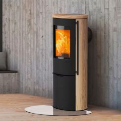 Foto de ambiente de la estufa de leña Liva 6 S de Lotus forrada en piedra Sandstone. Certificada para Passivhaus